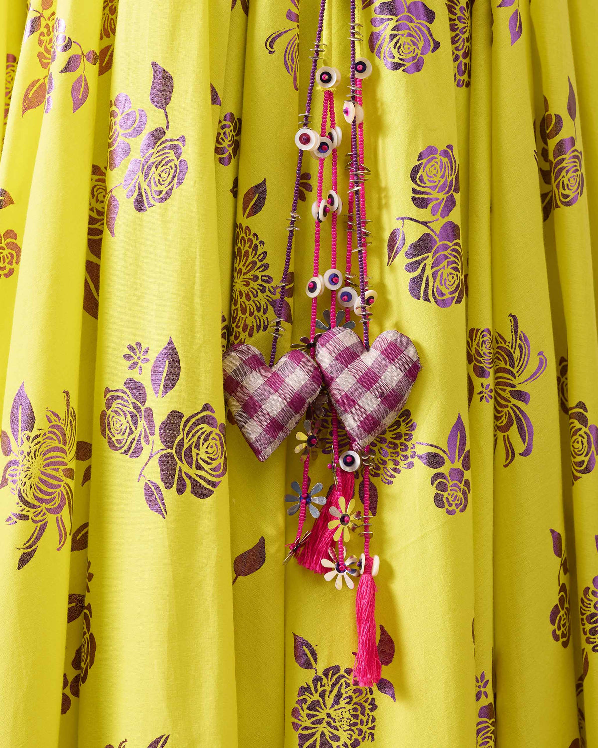 Close-up of heart tassels on a lime and purple printed Noor skirt.