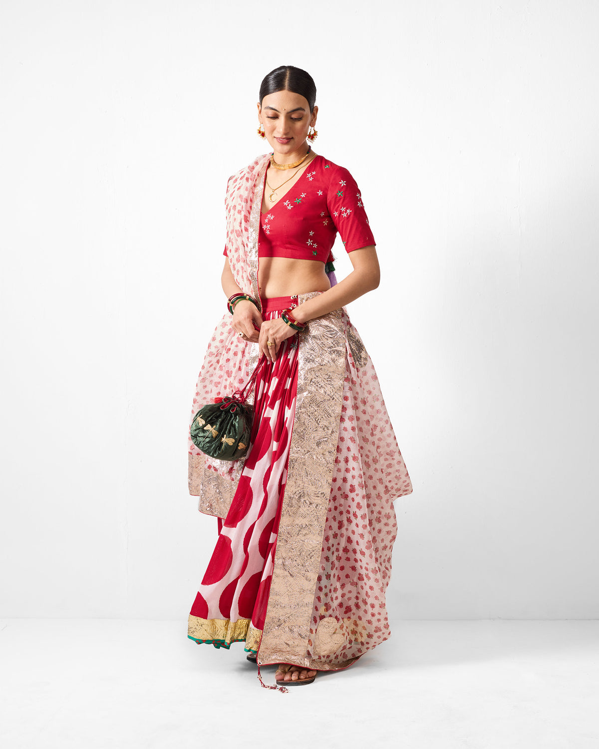 Person wearing a red and ivory Lehar dupatta with a metallic border.
