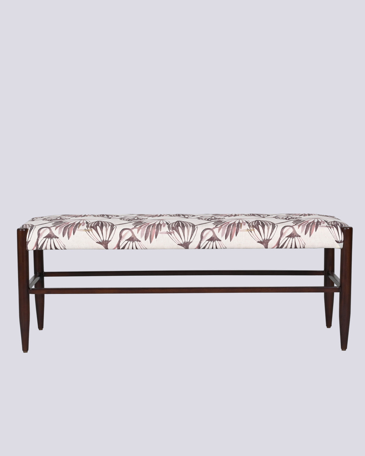 Moor Bench upholstered in cream fabric with a mauve botanical motif and dark wooden legs.