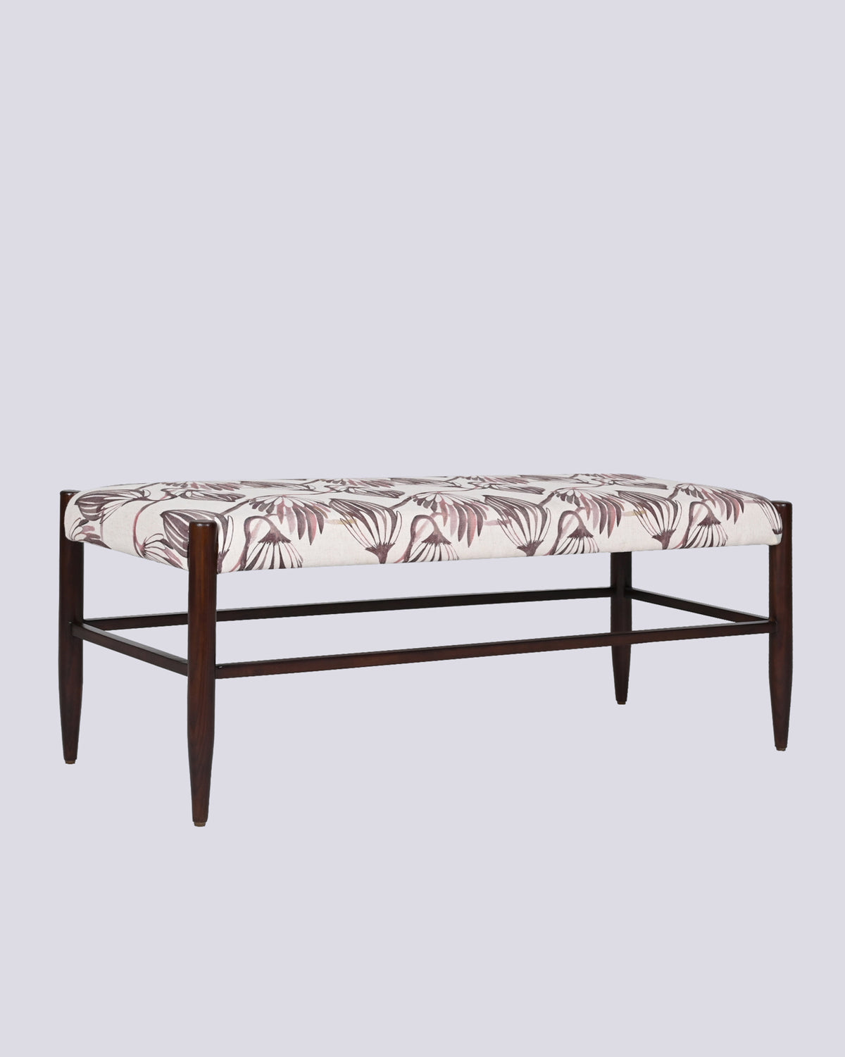 Three-quarter view of the Moor Bench with cream upholstery and dark wooden legs.