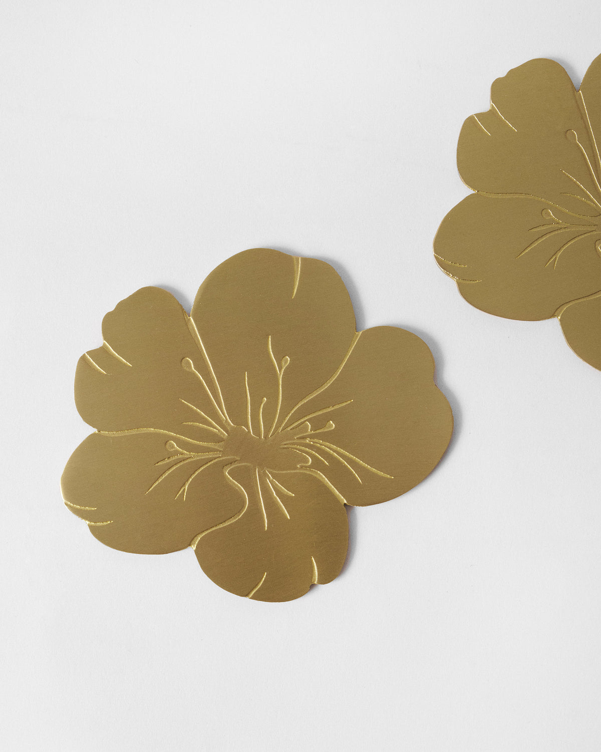 Almond Blossom Coasters on a light surface, showing embossed stamen lines.