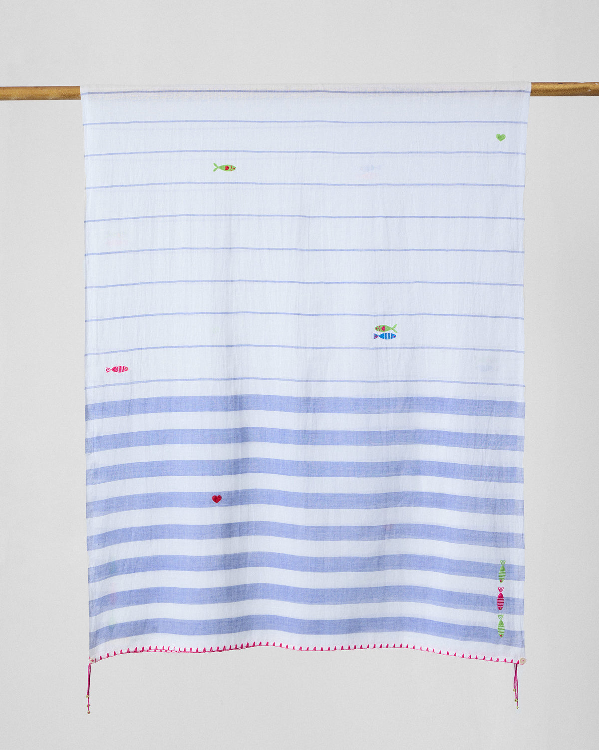 Skyline scarf hung flat, showing blue stripes and small embroidered fish.