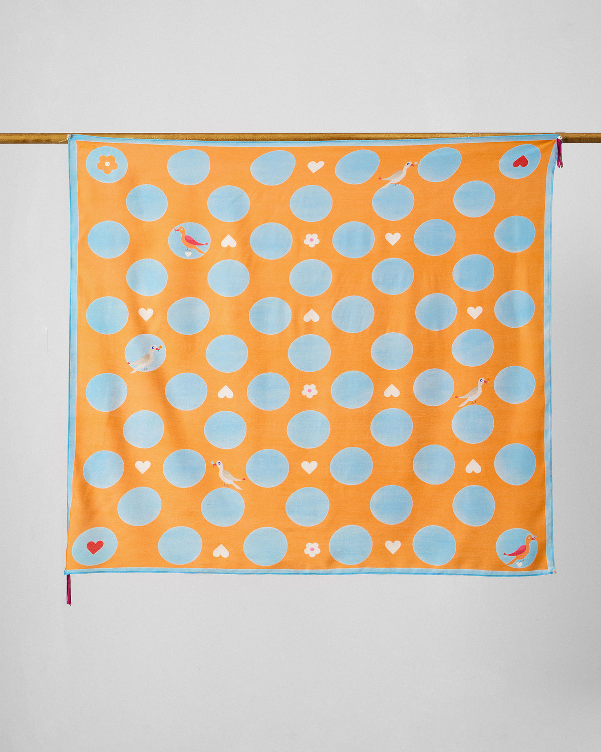 Dotty scarf hung flat, showing ice blue dots scattered with small birds and hearts.