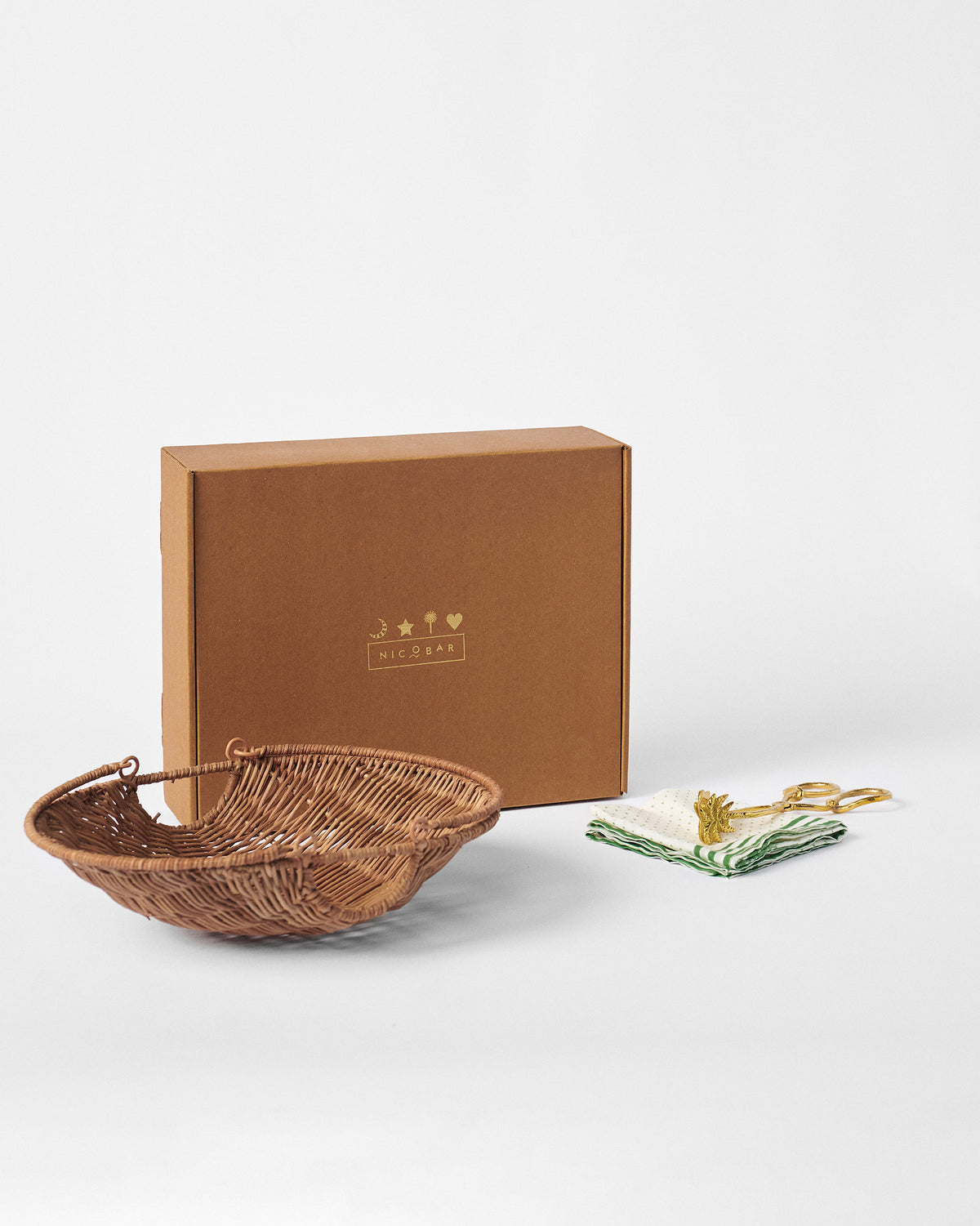 Rattan bread basket set arranged with its kraft Nicobar gift box.
