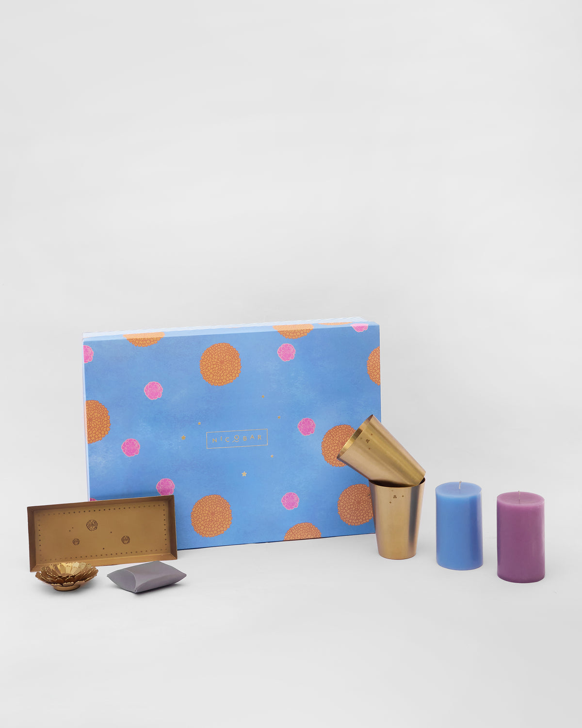 Marigold gift set with gold tray, tumblers and pillar candles.