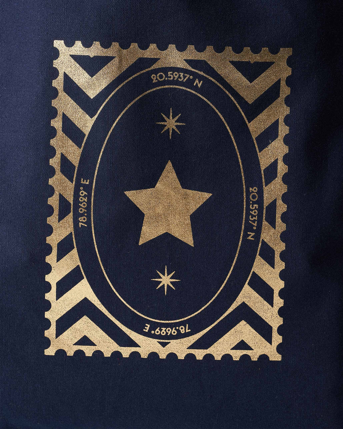 Close-up of the gold star stamp on a navy Mukayu City tote.