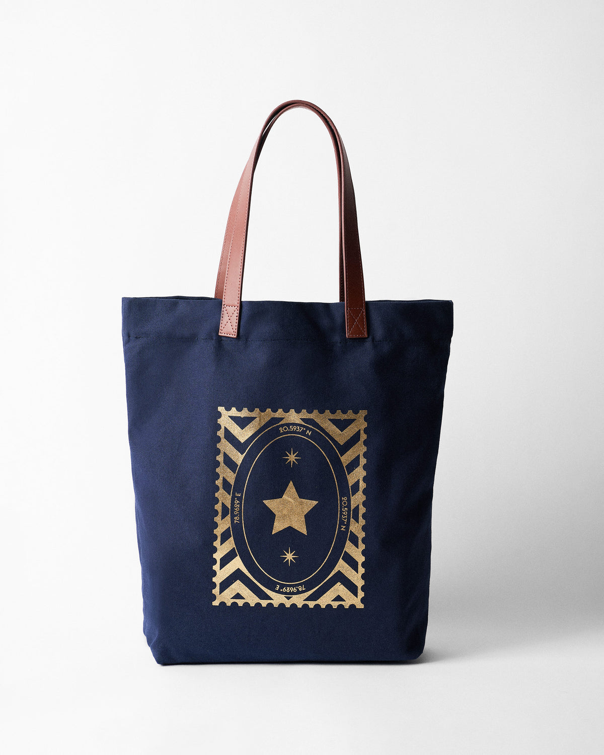 Navy Mukayu City tote with a gold star stamp and brown straps.