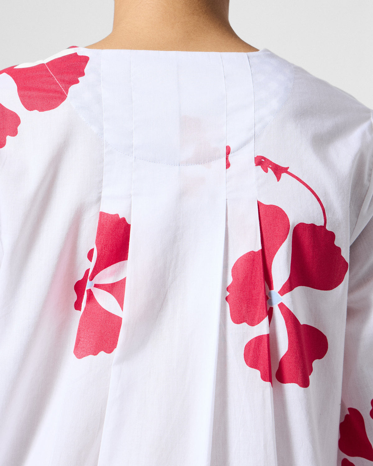 Close-up of the back yoke and pleats on a white and red printed Pampa kurta.