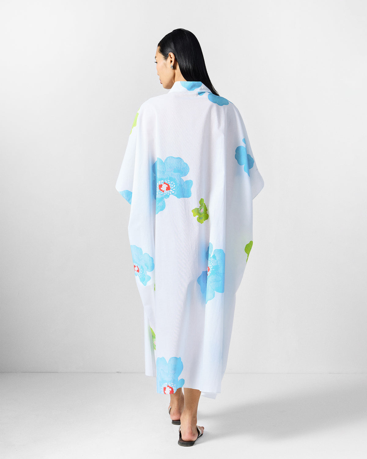 Back of a white Bea kaftan with blue and lime floral print.