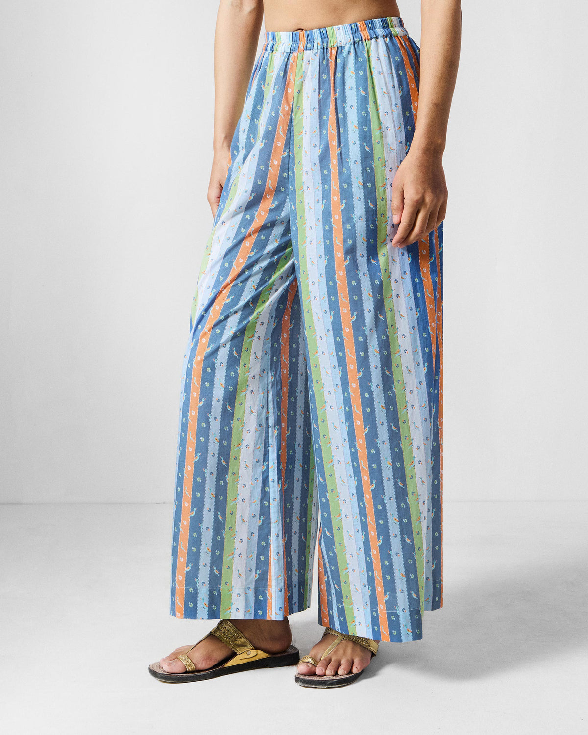 Person wearing multicolor striped Classic Pyjamas with a wide leg.