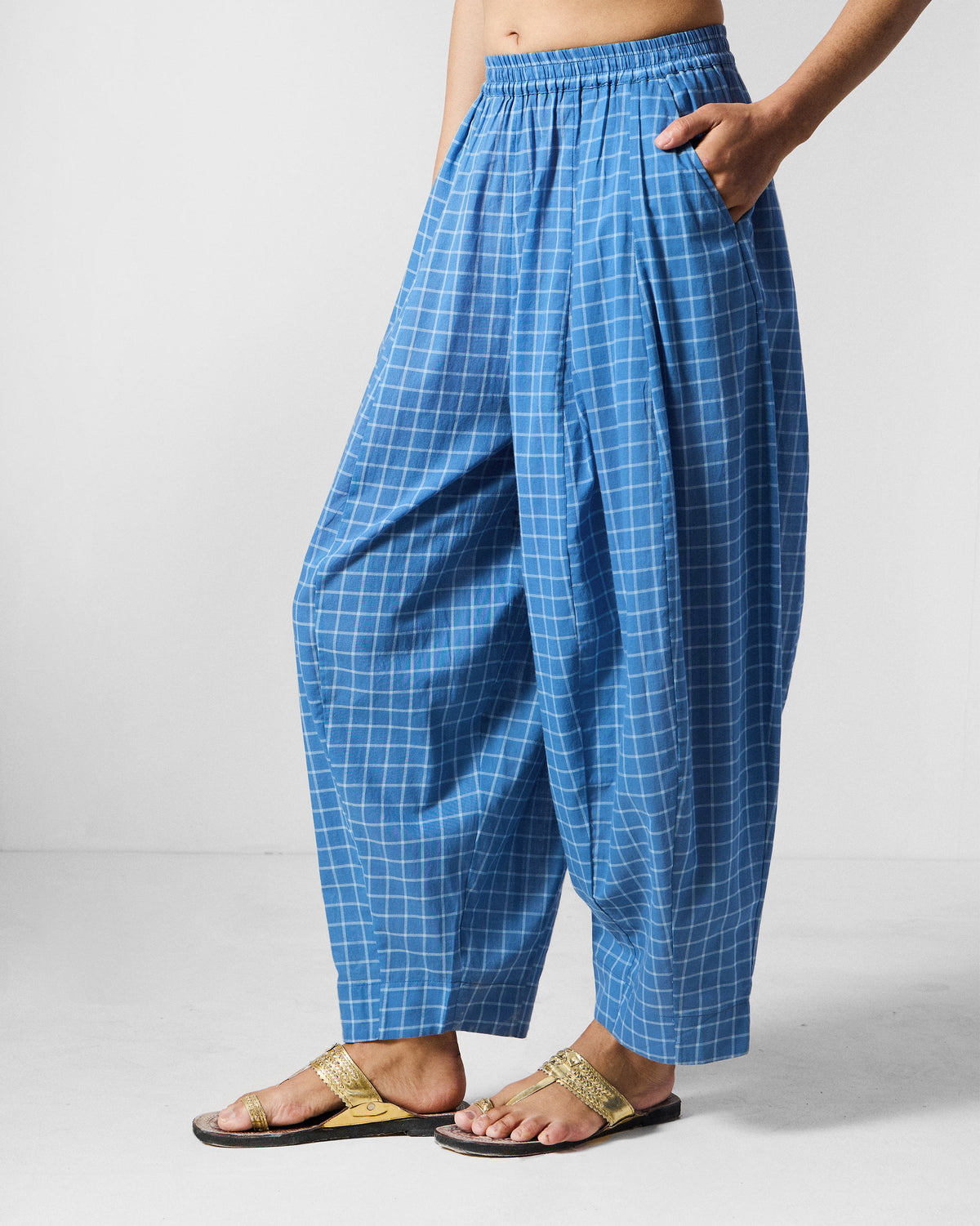 Side view of riverside blue and white check Tia Pants with a full draped leg.