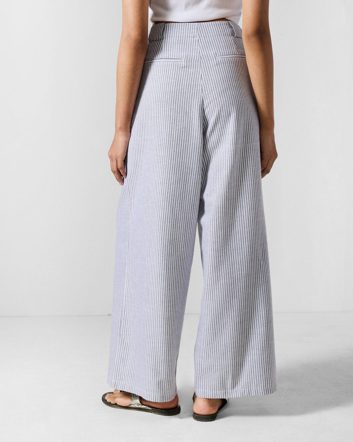 Back of grey and white striped Costa pants with welt pockets.