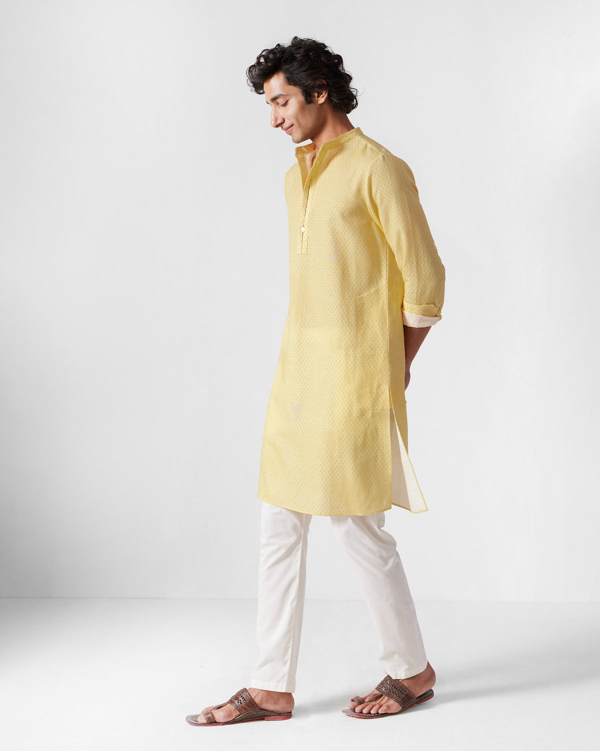 Side view of a light yellow Astral kurta with a subtle print.