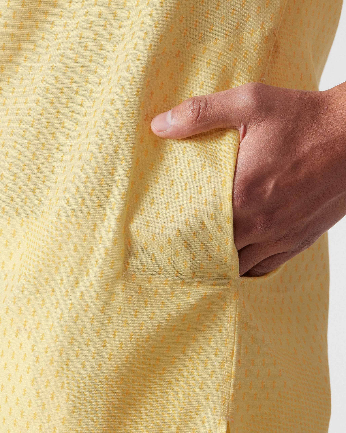 Close-up of a side pocket on a light yellow Astral kurta.