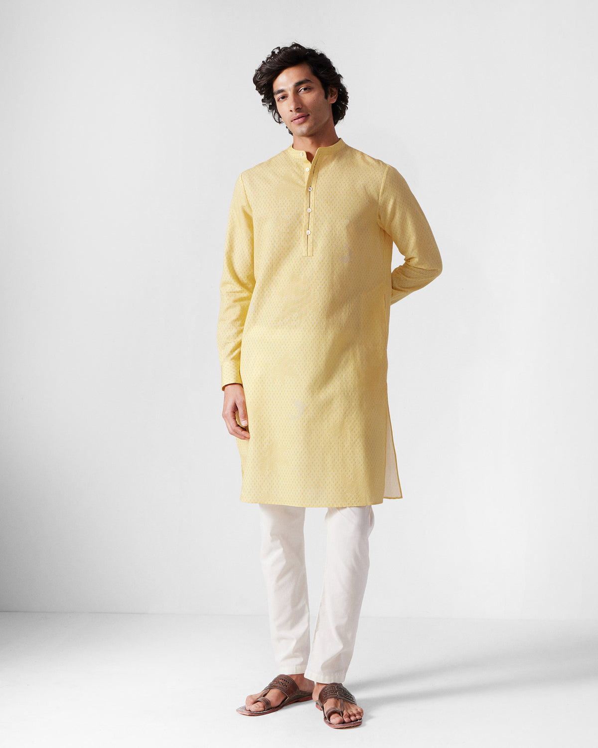 Person wearing a light yellow Astral kurta with a subtle print.