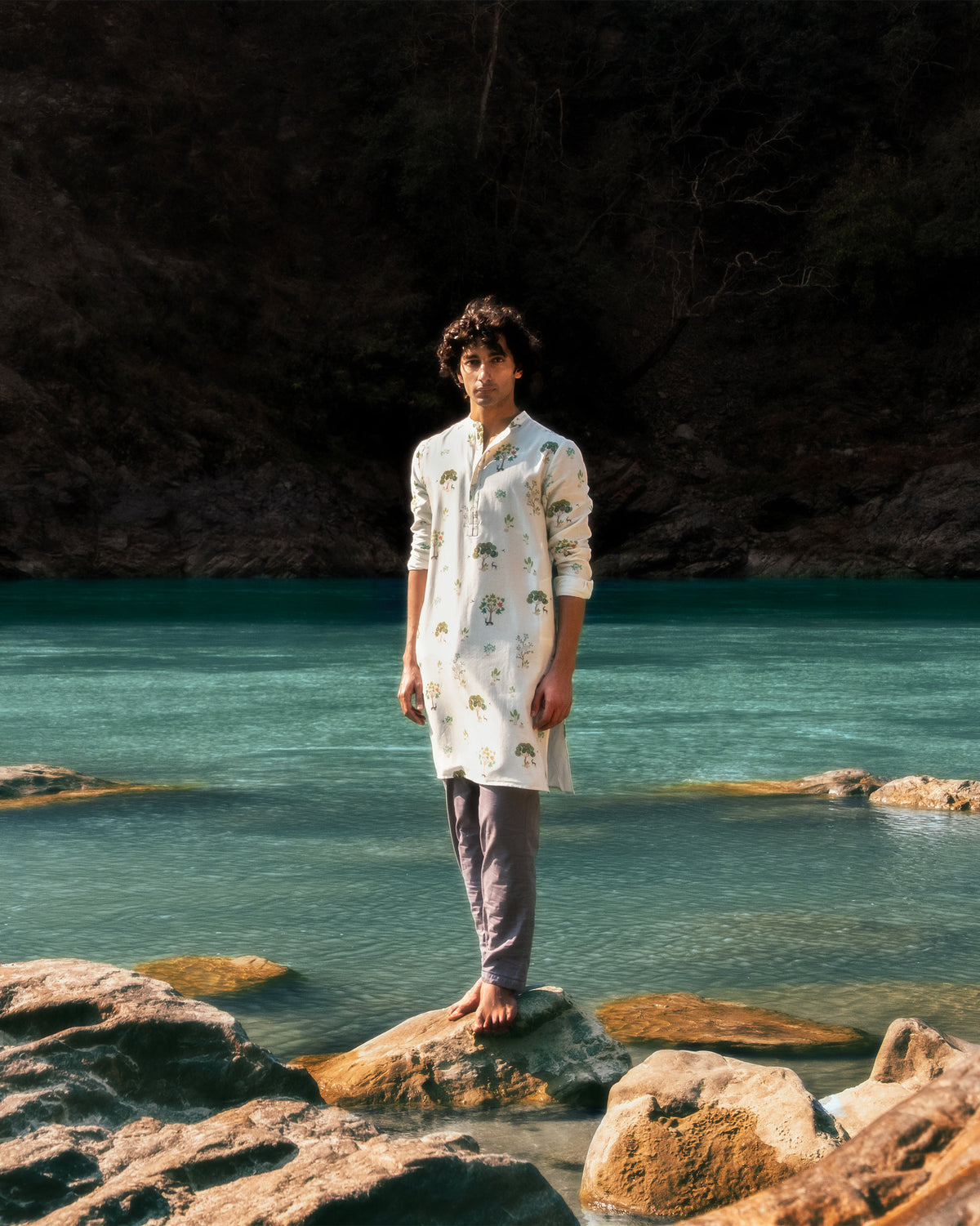 Ivory Astral kurta with green tree print worn outdoors.