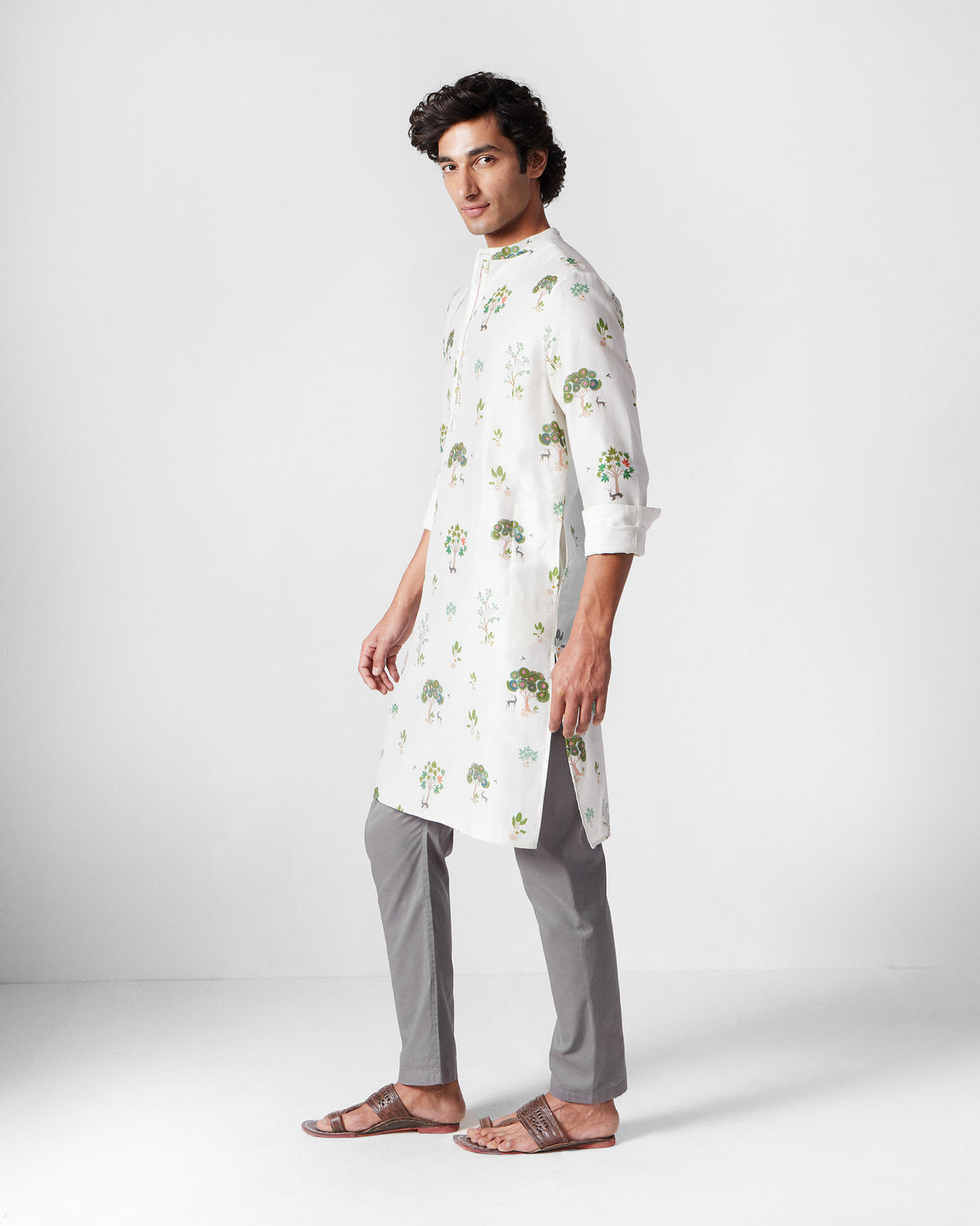 Side view of an ivory Astral kurta with green tree valley print.