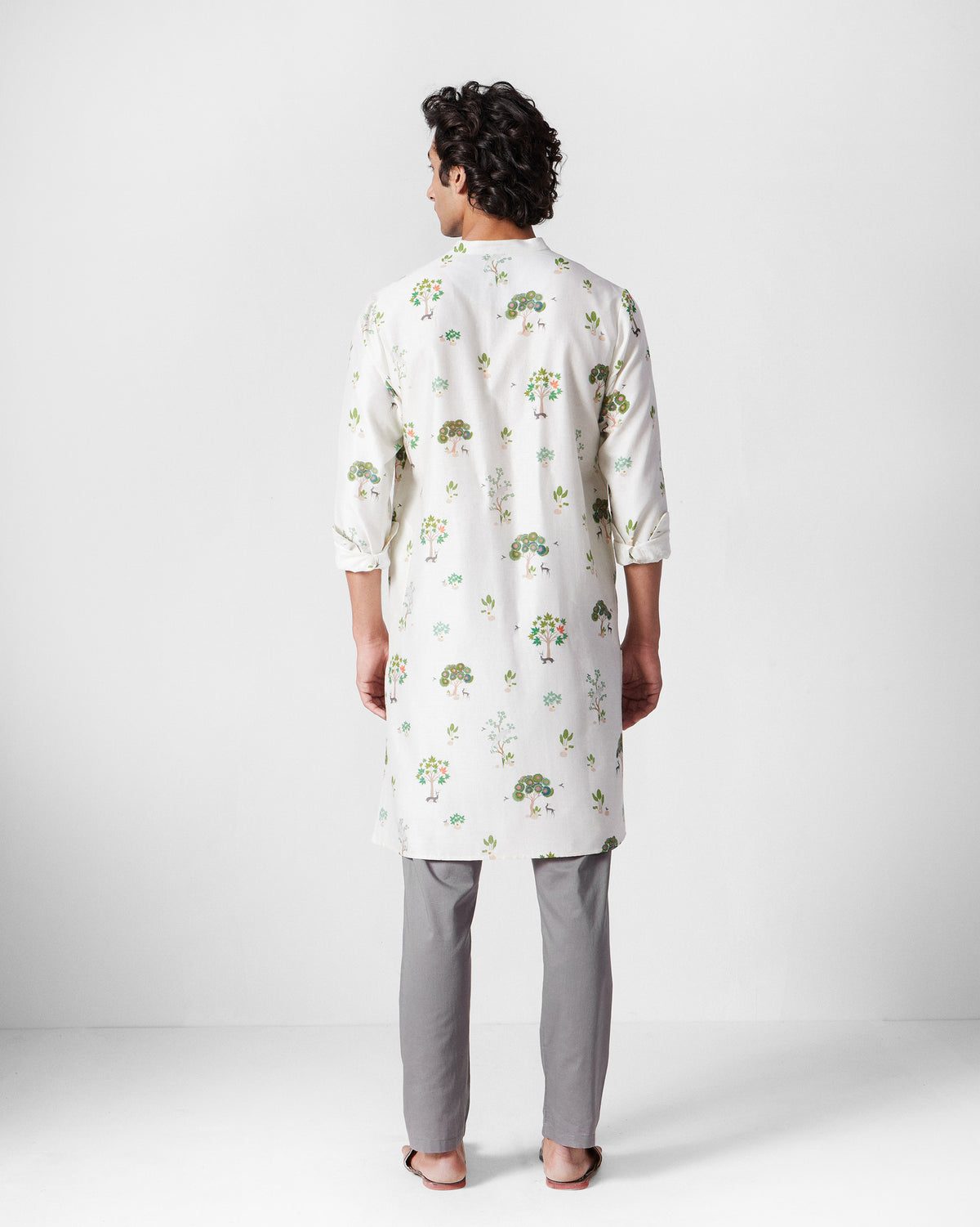 Back of an ivory Astral kurta with all-over green tree print.