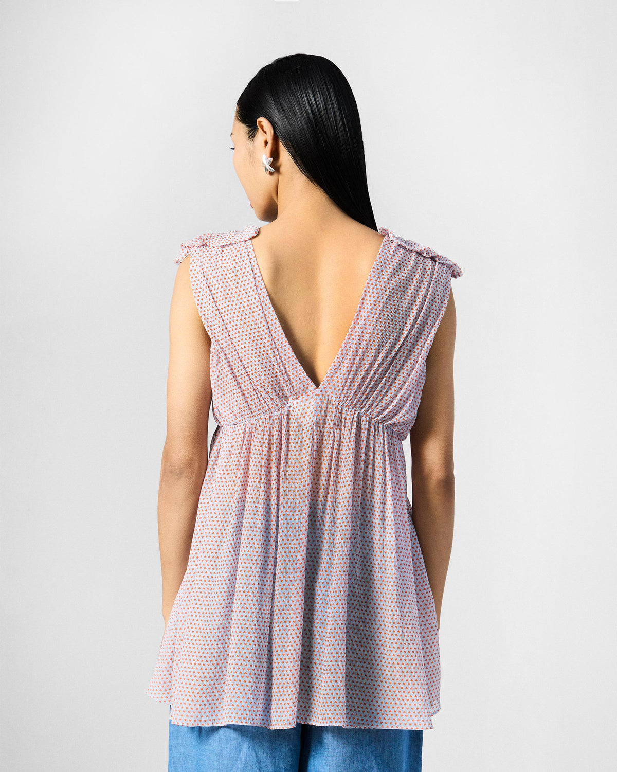 Back of a blue printed Sira top with a V-back worn by a person.