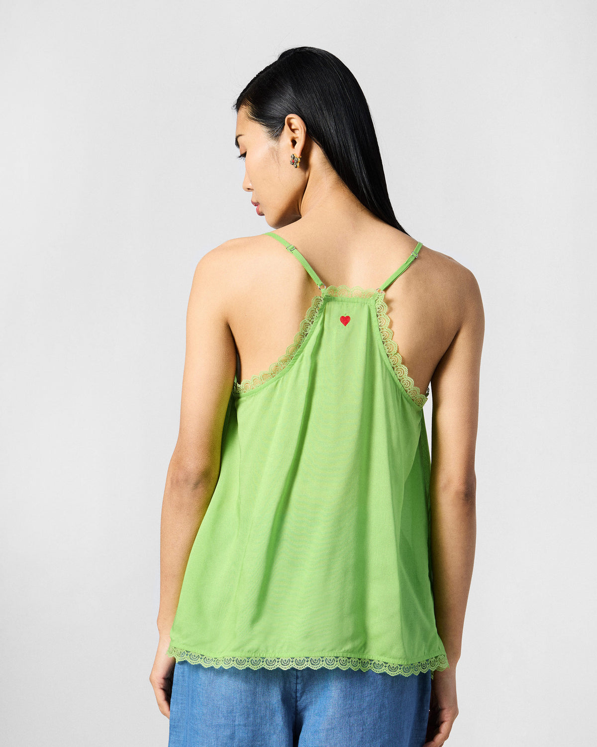 Back of the lime green Jora slip with a red embroidered heart.