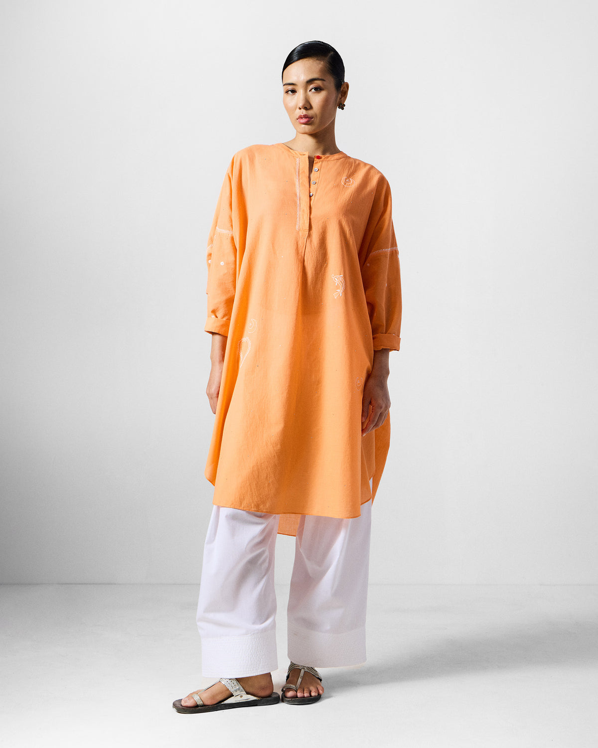 Orange Lazy Sunday tunic with white embroidery and a relaxed longline fit.
