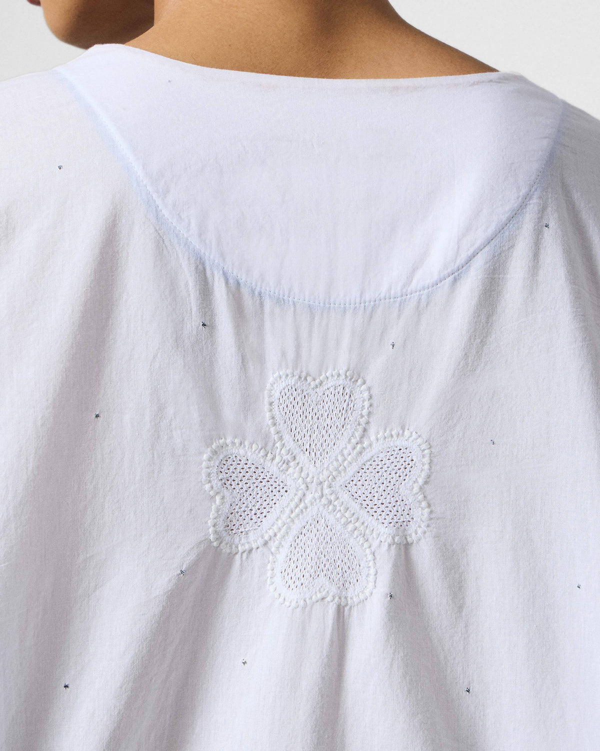 Close-up of white-on-white embroidery on the back of a Calicut kurta.