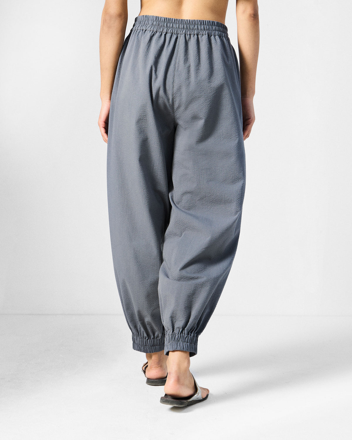 Back of charcoal joggers with gathered waist and ankle cuffs.