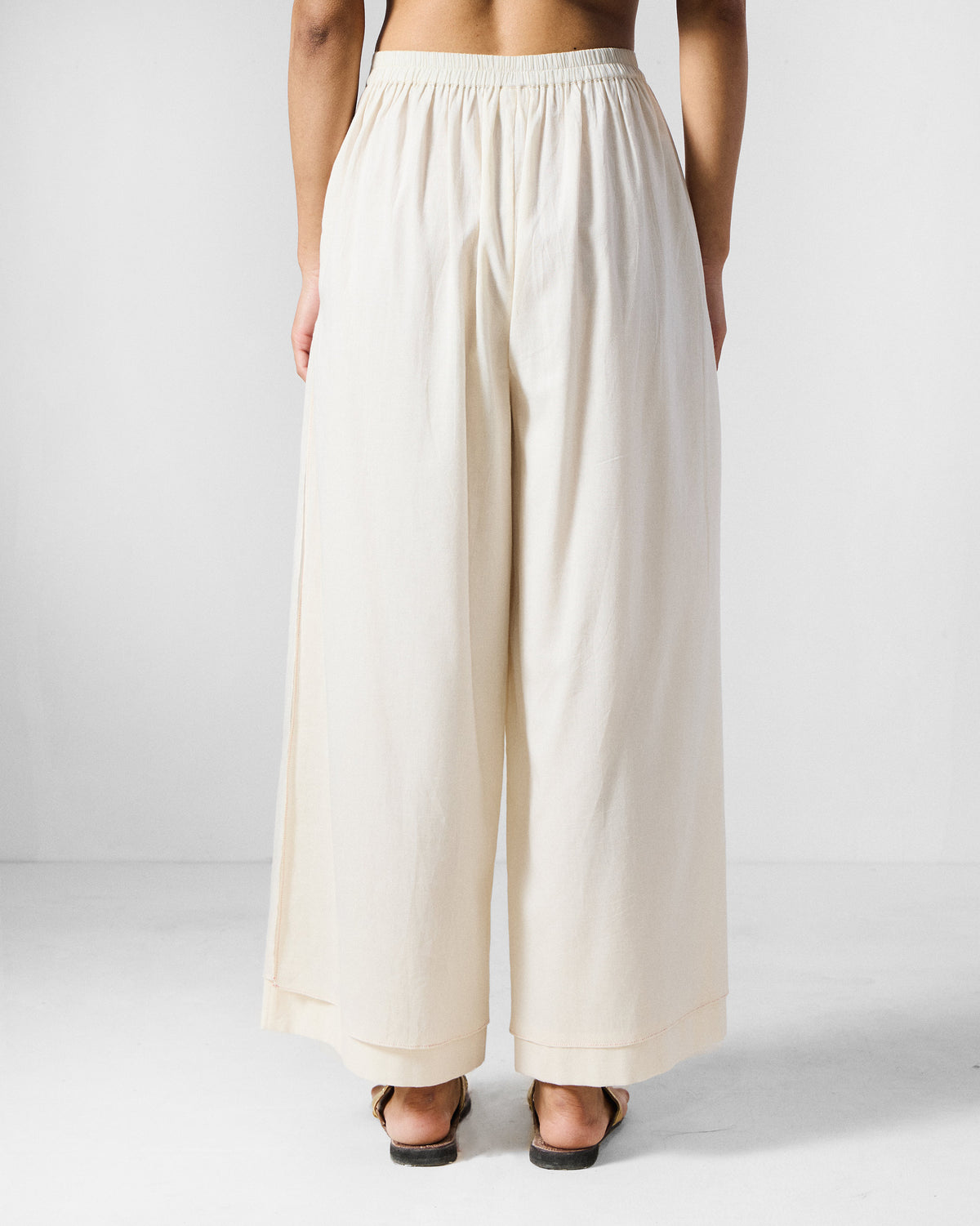 Back of ivory wide-leg Breeze pants with a gathered elastic waist.