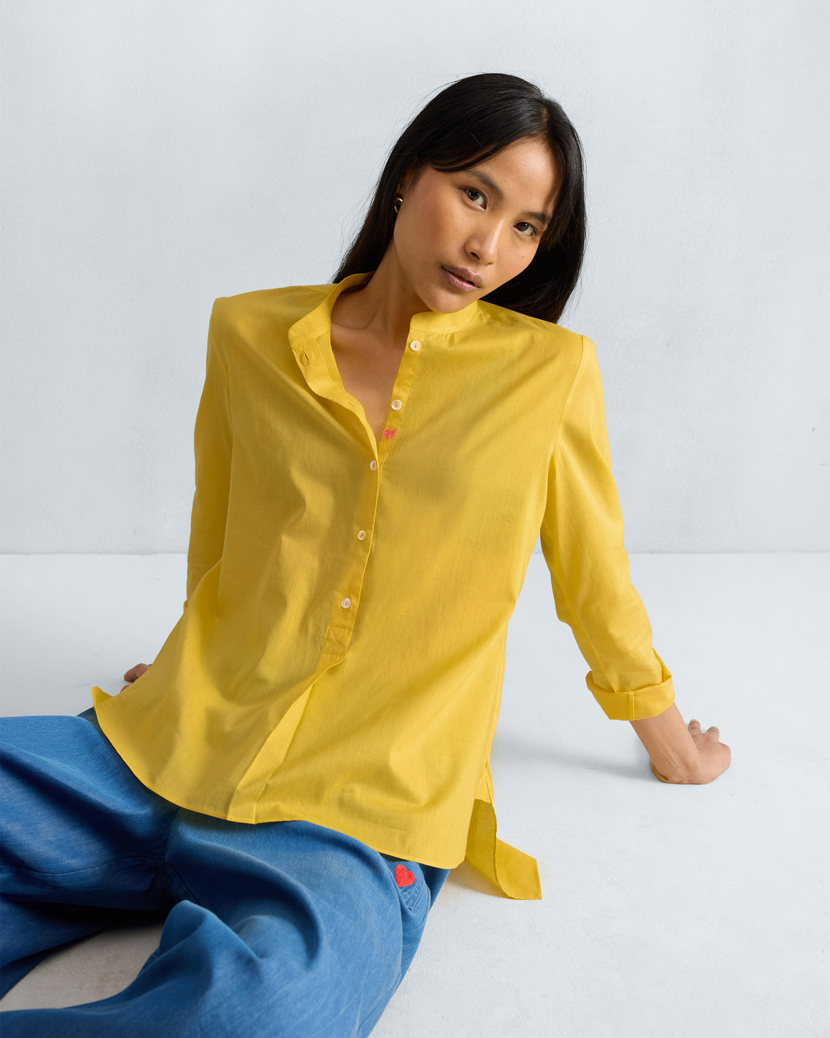 Person wearing a yellow mandarin collar top.