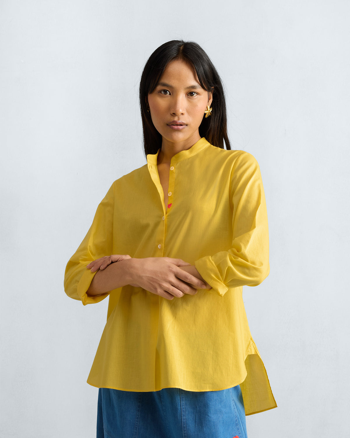 Person wearing a yellow mandarin collar top.