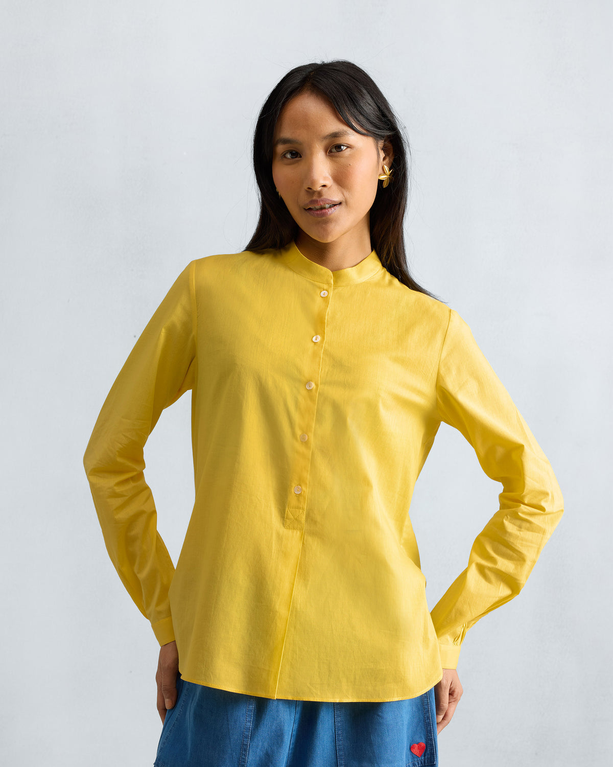 Person wearing a yellow mandarin collar top.