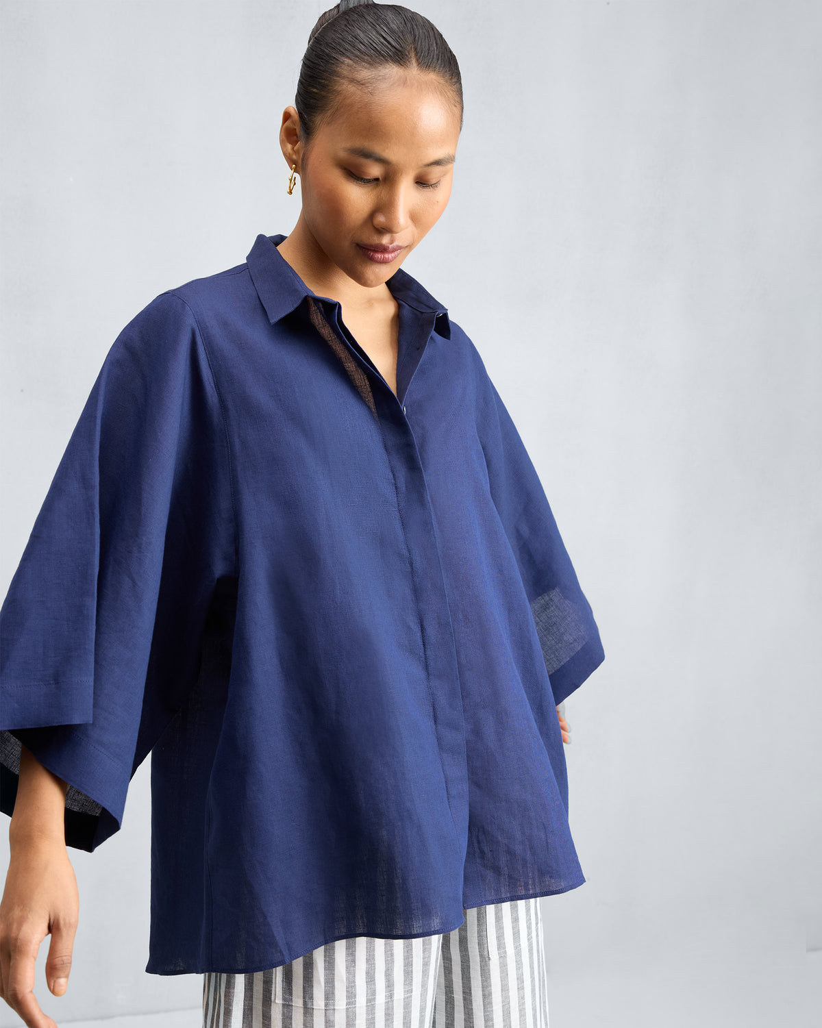Person wearing an ink blue drop armhole shirt.
