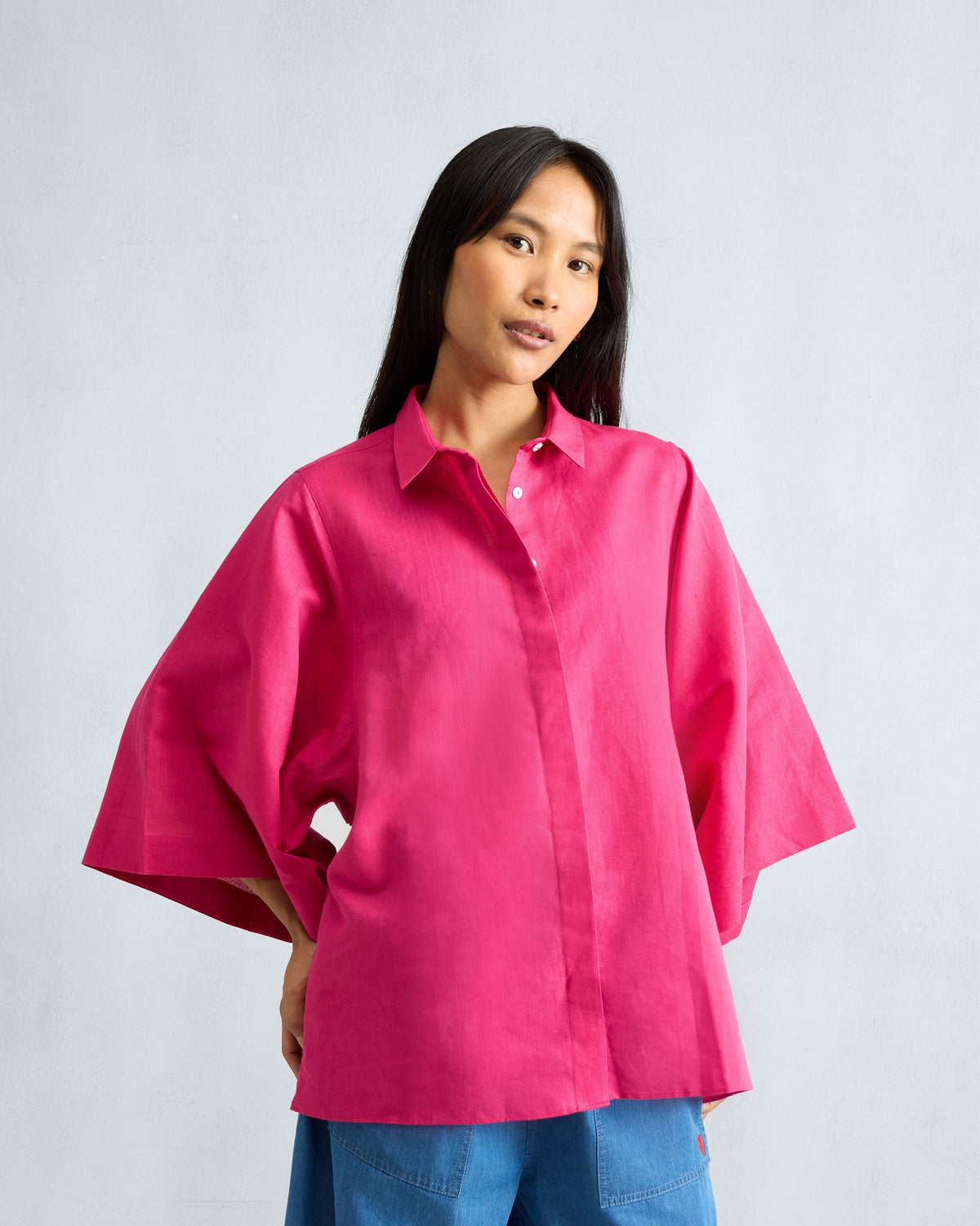 Person wearing a fuchsia Drop Armhole Shirt with wide sleeves.