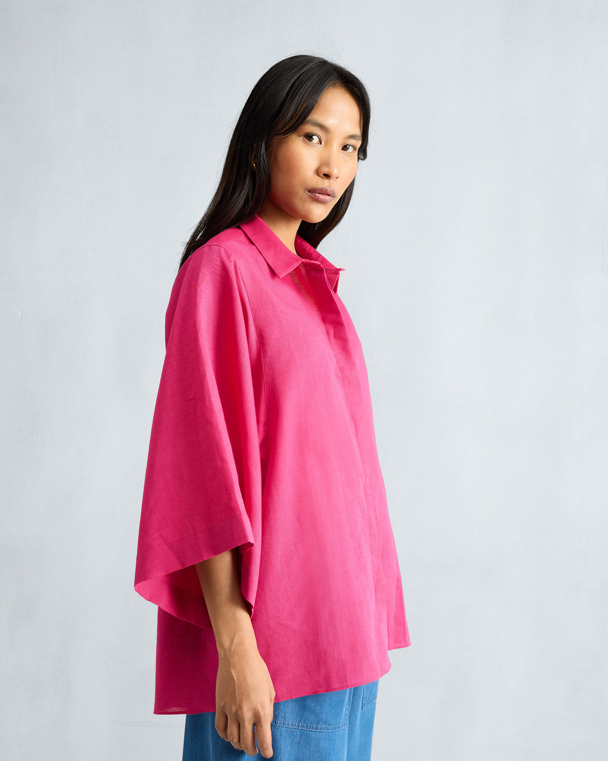 Side view of a fuchsia Drop Armhole Shirt with wide sleeves.