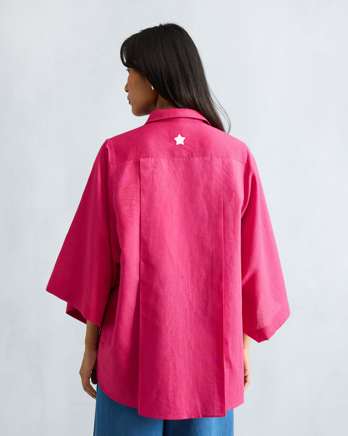 Back of a fuchsia Drop Armhole Shirt with a white star on the yoke.