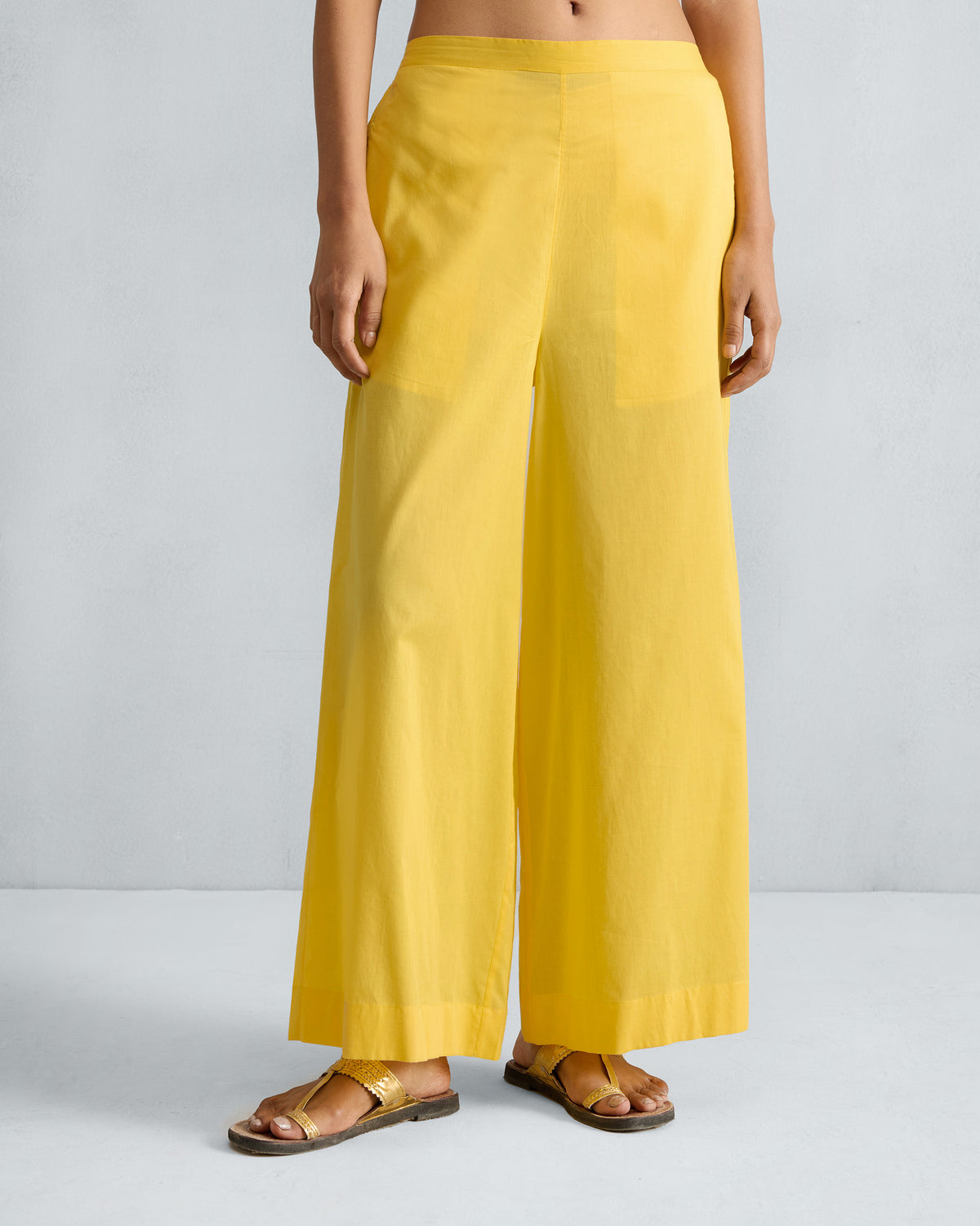Person wearing yellow Basic Pyjamas with wide legs.