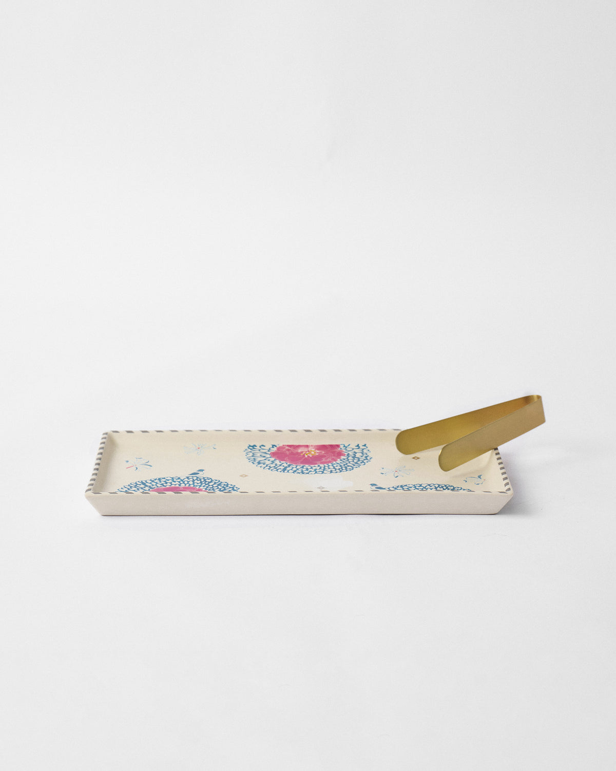 Marigold Cookie Tray With Tong with pink flowers and blue scalloped motifs.