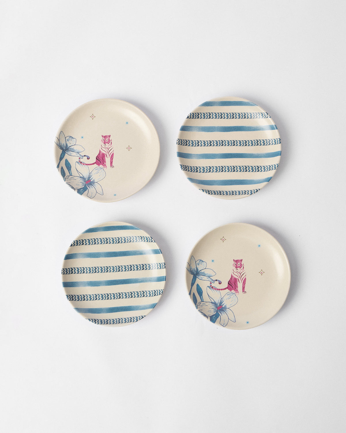 Set of four River Tiger tea plates with tiger and stripe designs.