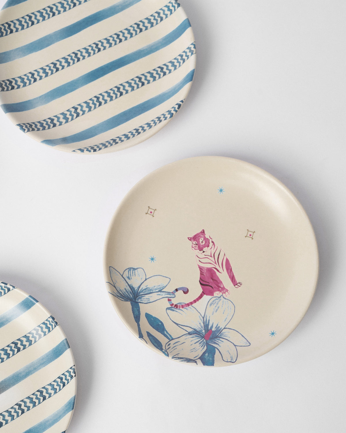 River Tiger tea plate with a pink tiger among blue flowers.