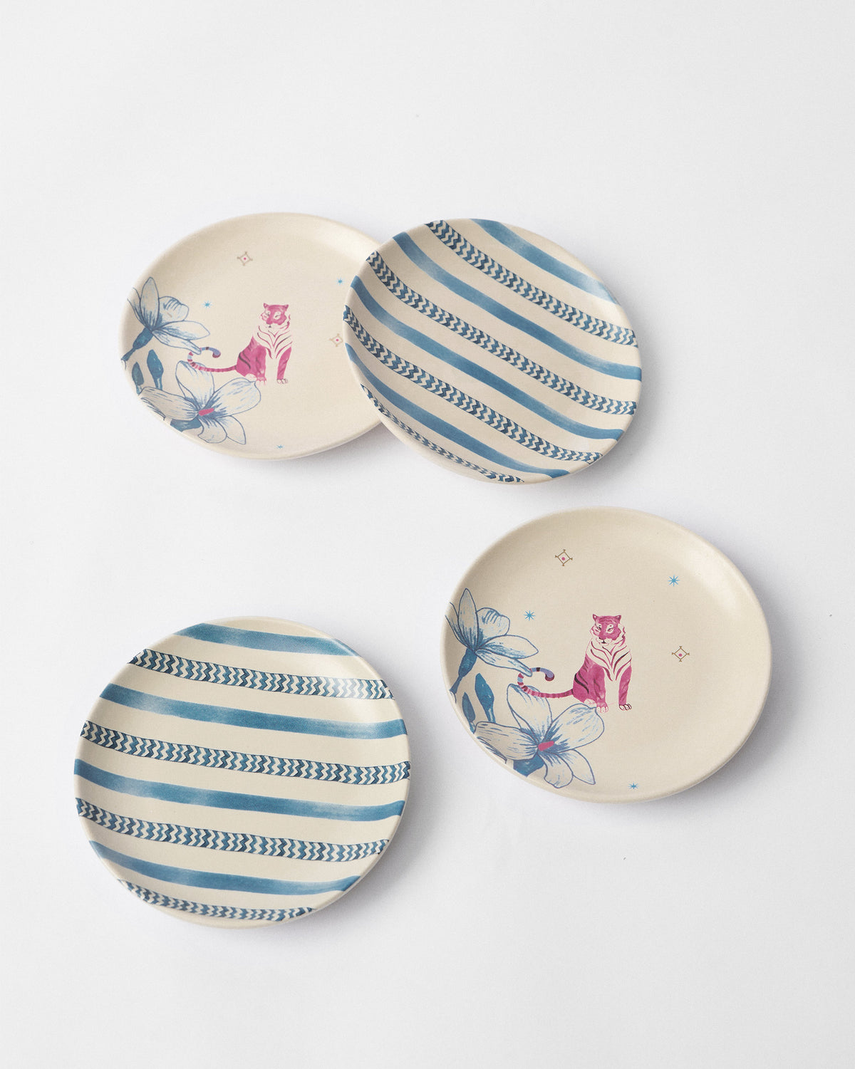 Four River Tiger tea plates alternating tiger and stripe patterns.