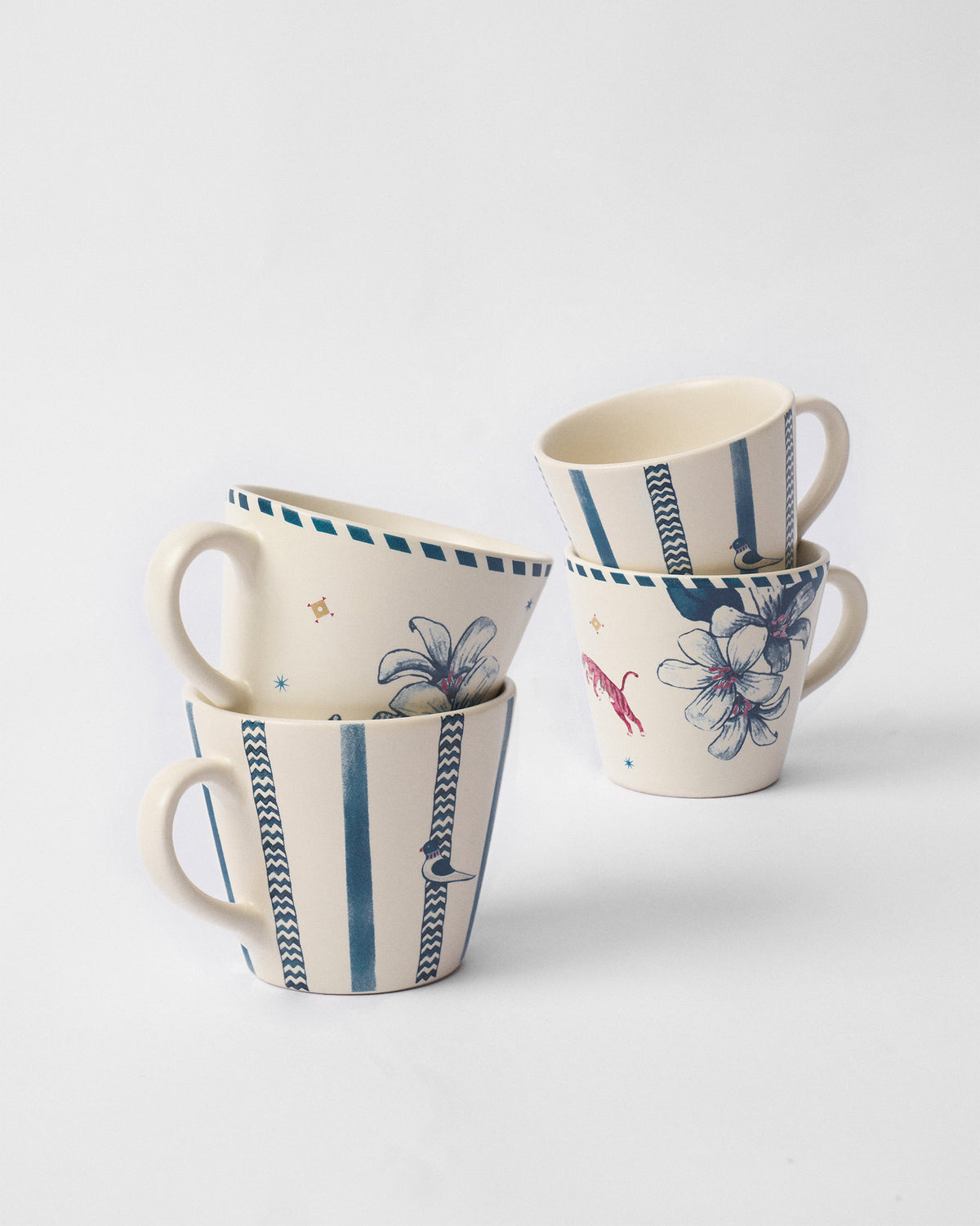 River Tiger espresso mugs stacked in pairs showing tiger, floral, and bird motifs.