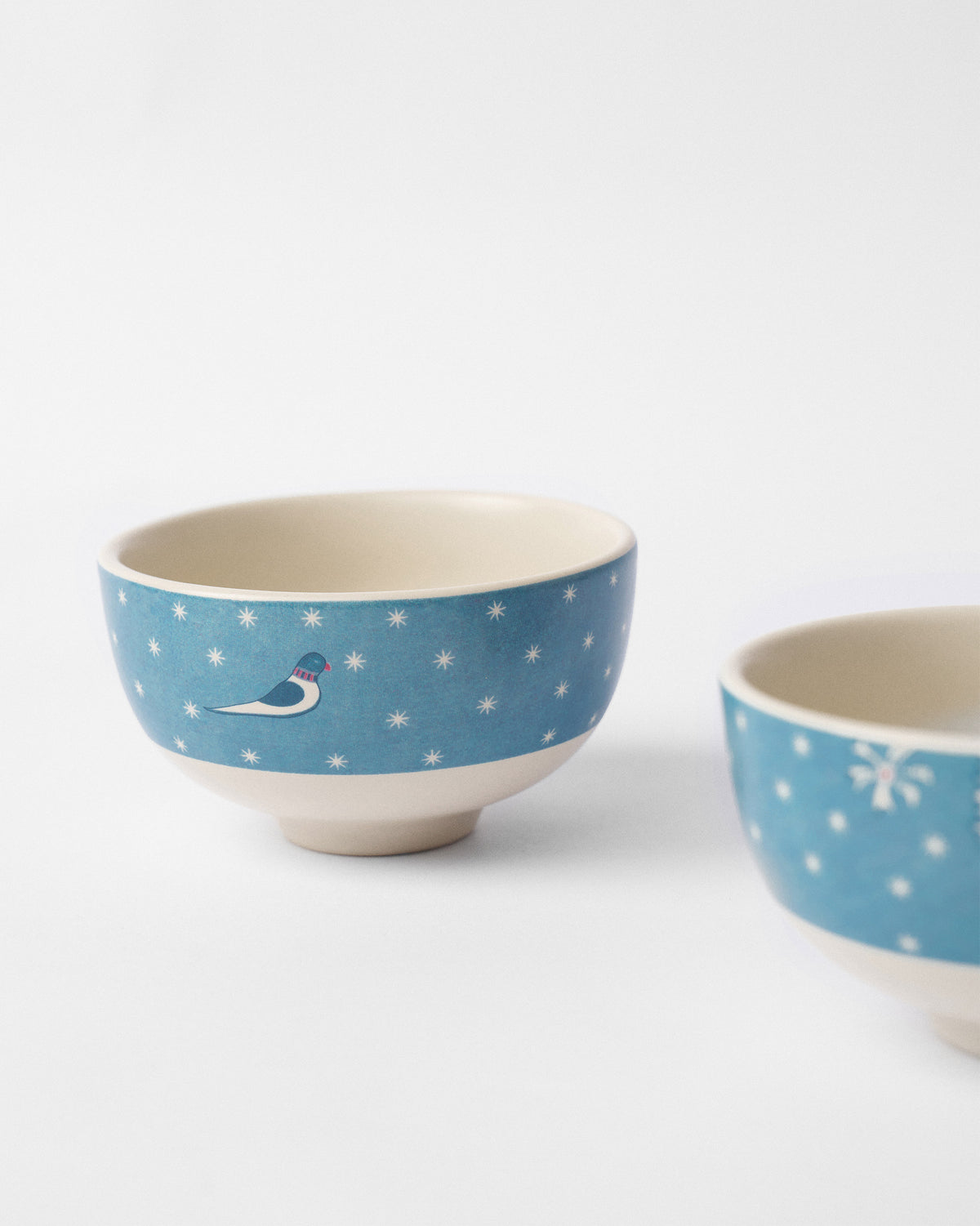 Marigold nibble bowl with a blue bird on a star-dotted band.