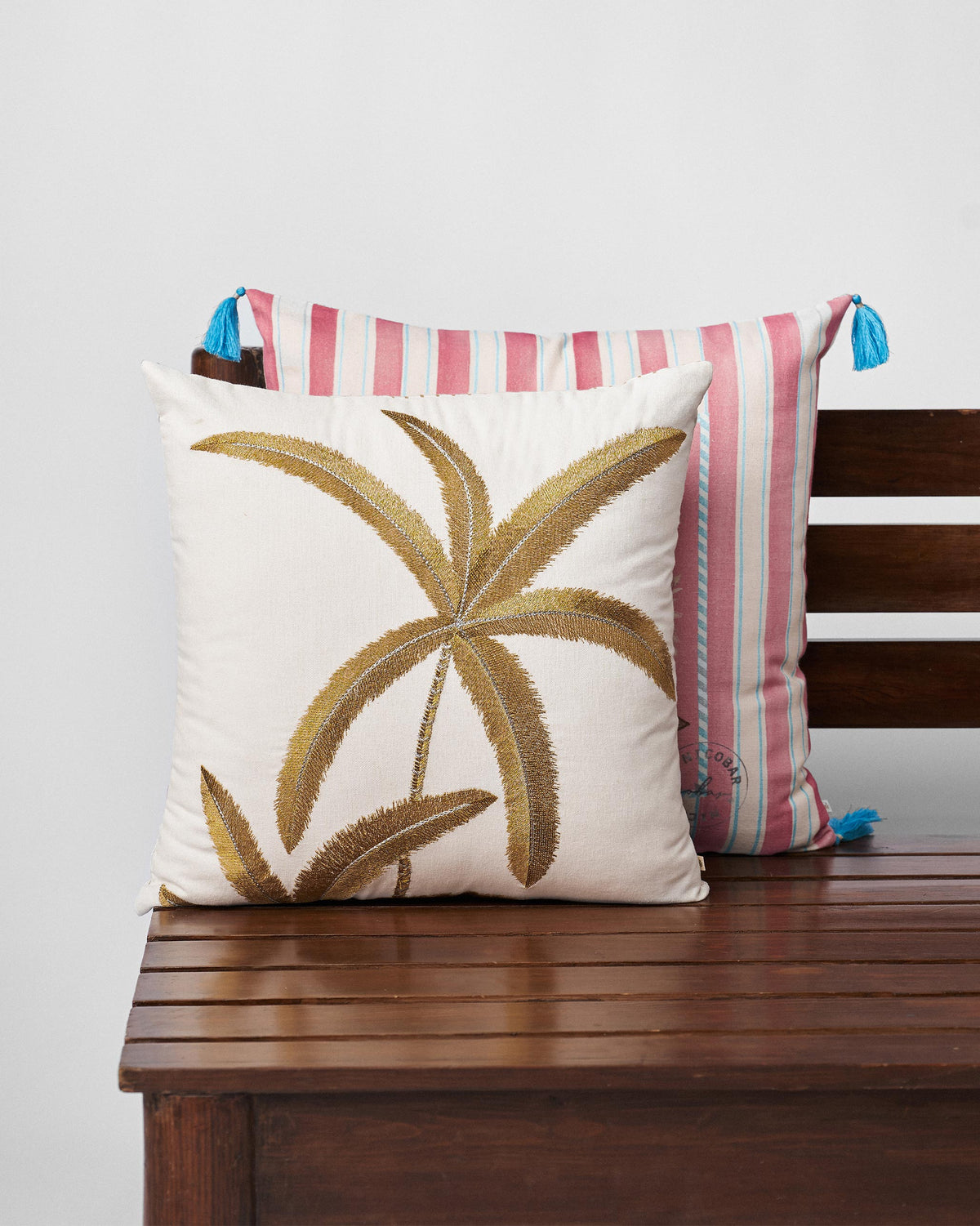 Palm Dance cushion cover with a large gold embroidered palm.