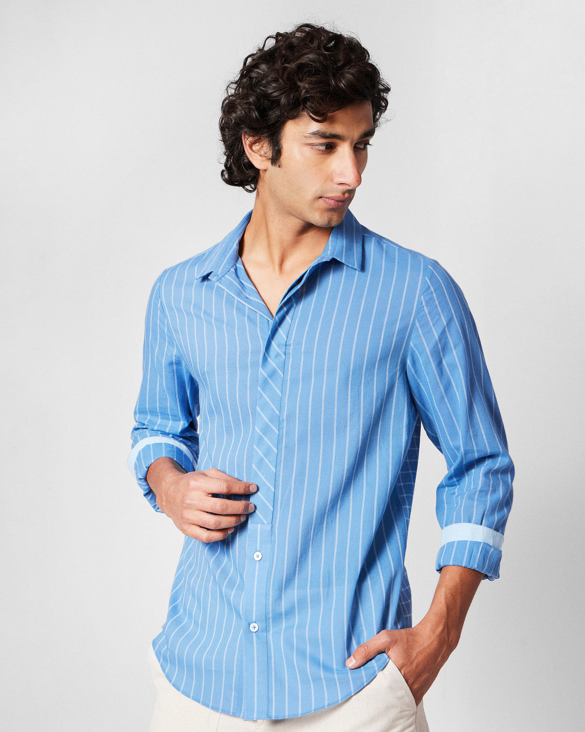 Person wearing a riverside blue Bias Placket shirt with diagonal placket stripes.