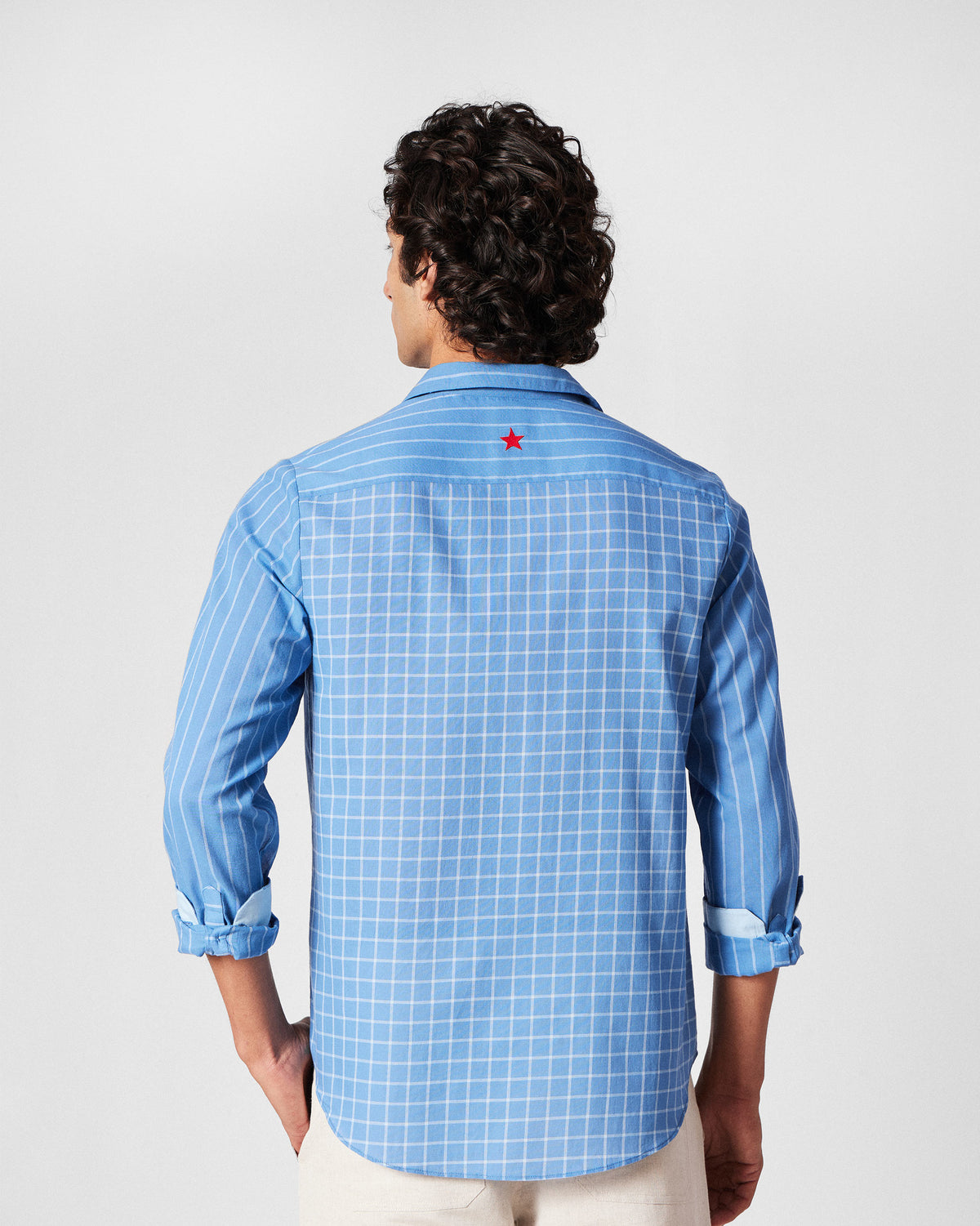 Back of a riverside blue Bias Placket shirt with checks and a red star.
