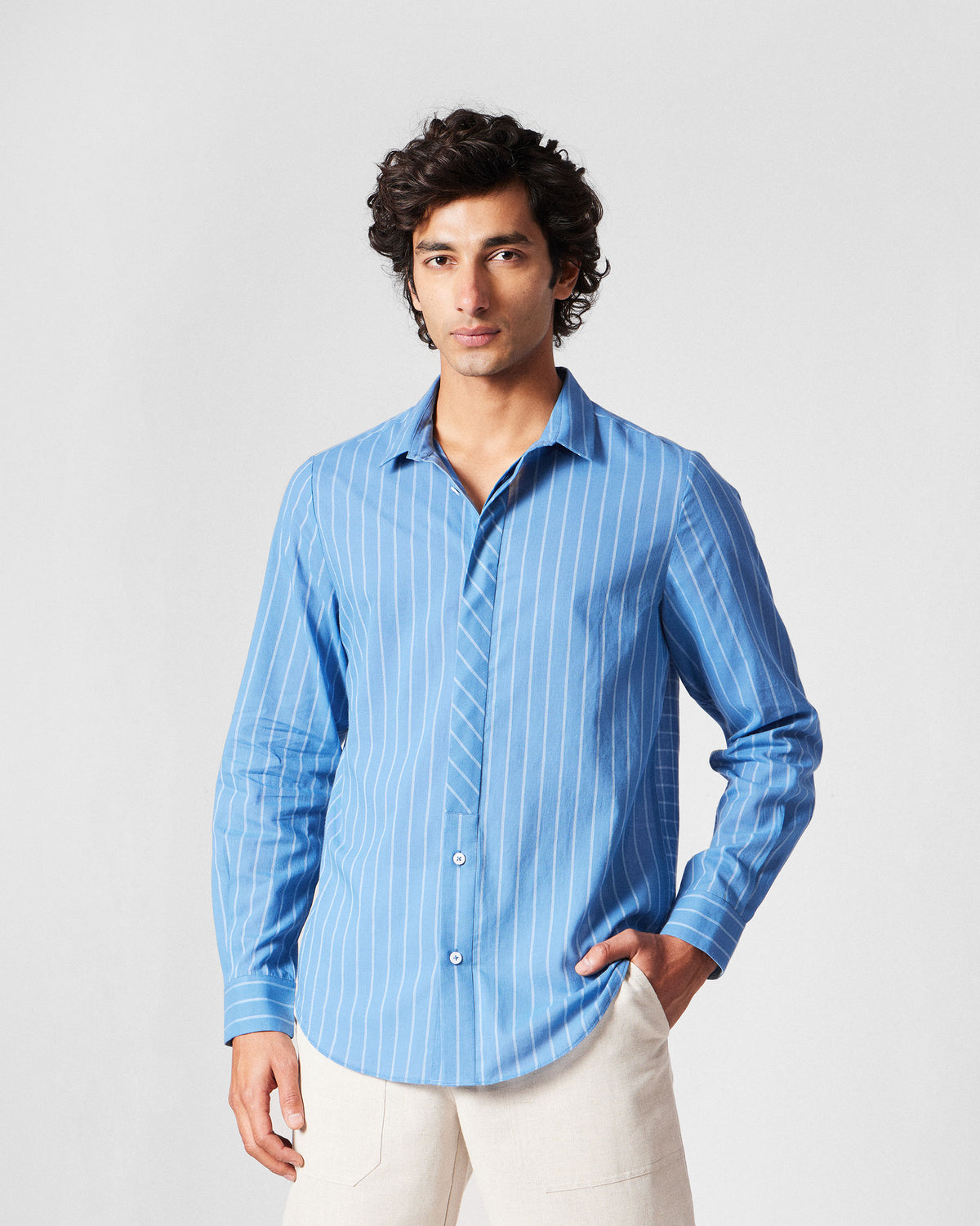 Person wearing a riverside blue Bias Placket shirt with a diagonal-stripe placket.