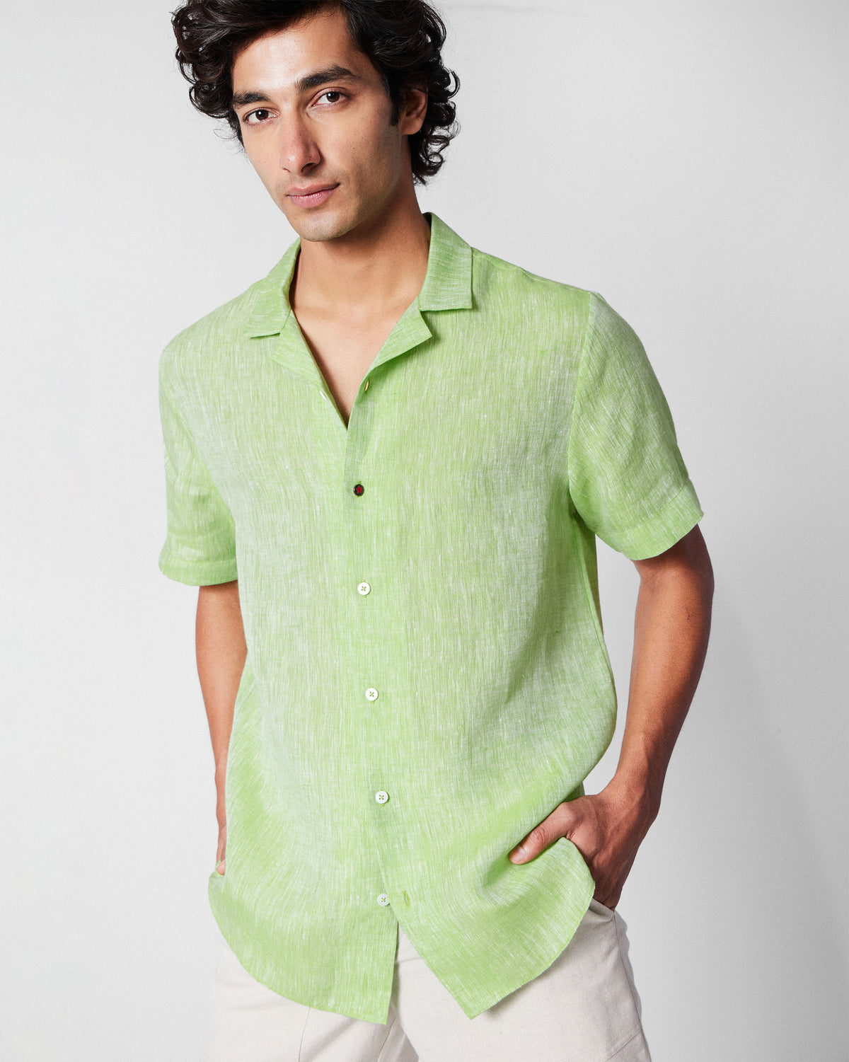 Person wearing a light green Mistari shirt with a camp collar.