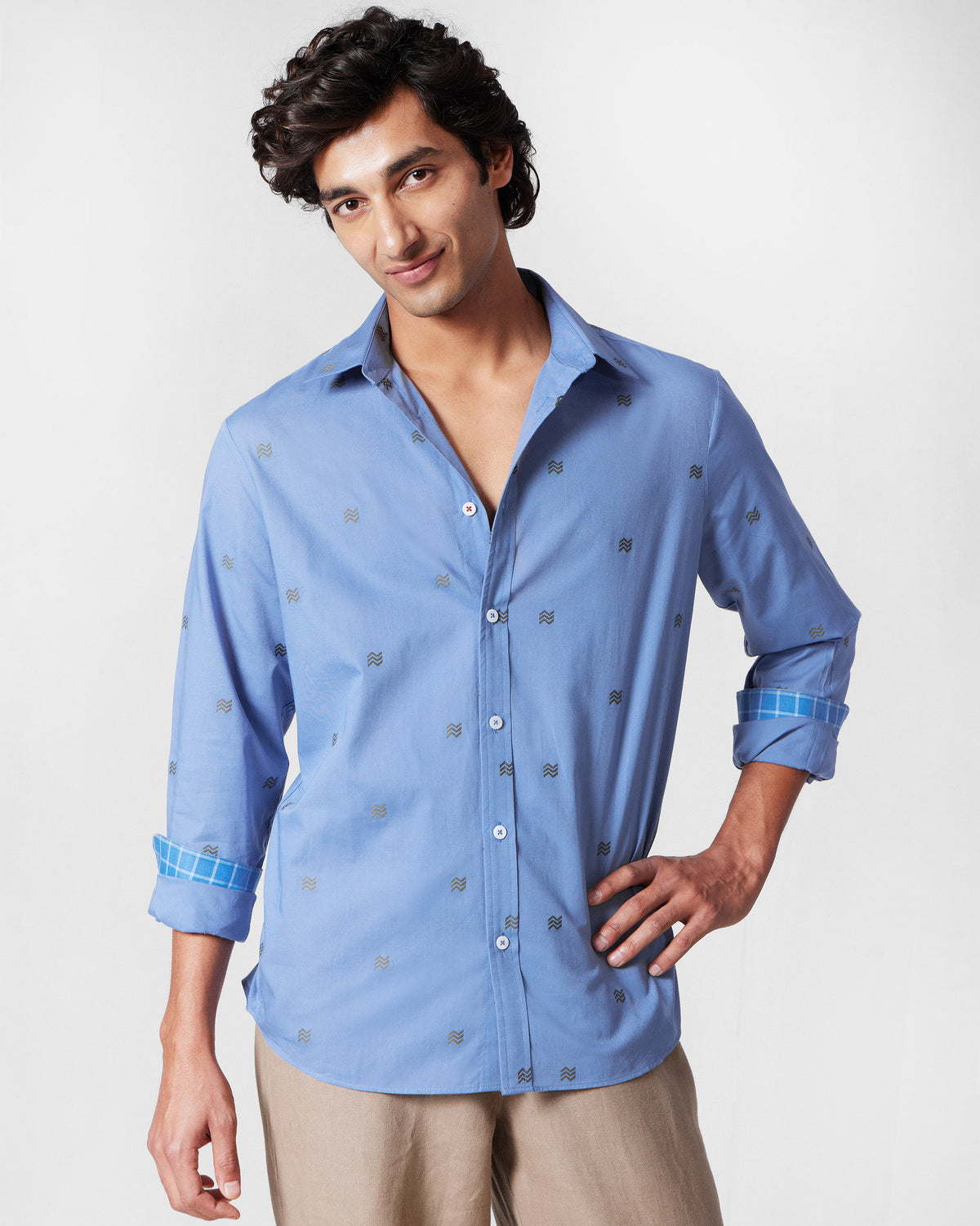 Blue Sindhu Shirt worn with sleeves rolled to show a windowpane cuff lining.