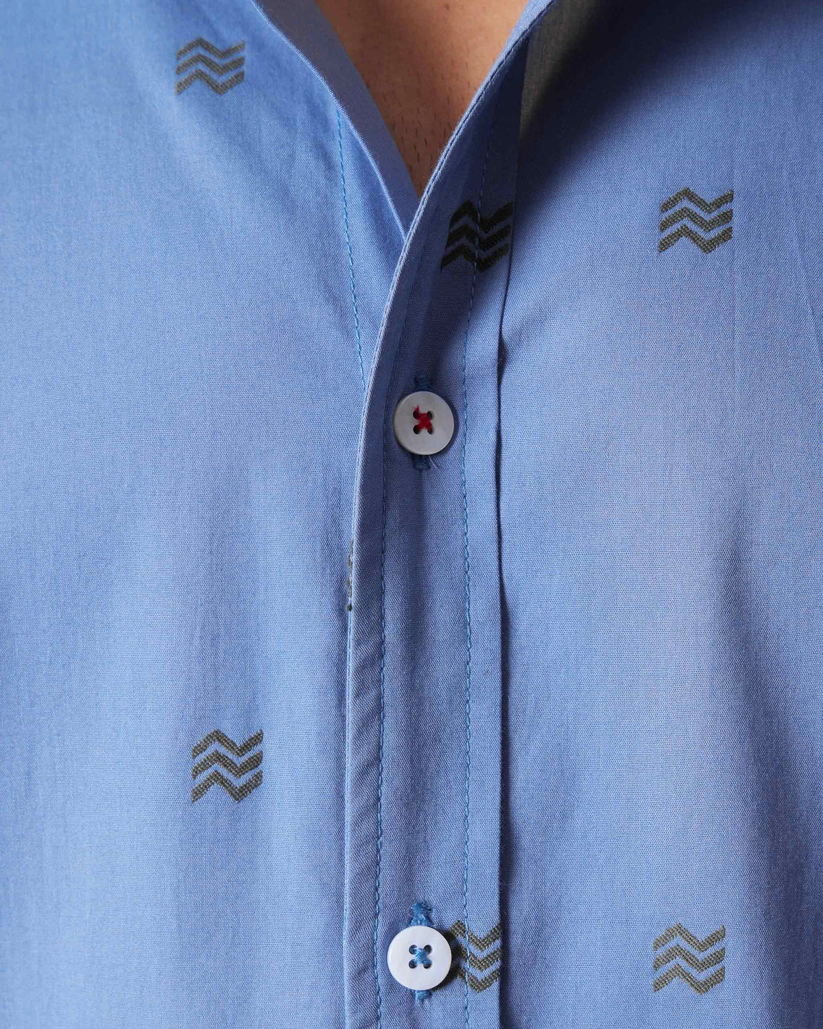 Close-up of the wavy motif print and buttons on a blue Sindhu Shirt.