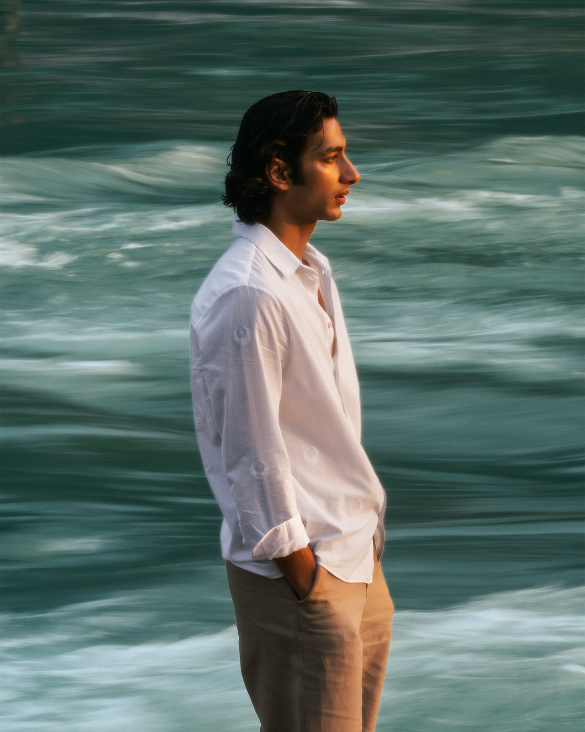 Side profile of a white Basalt shirt with tonal embroidery.